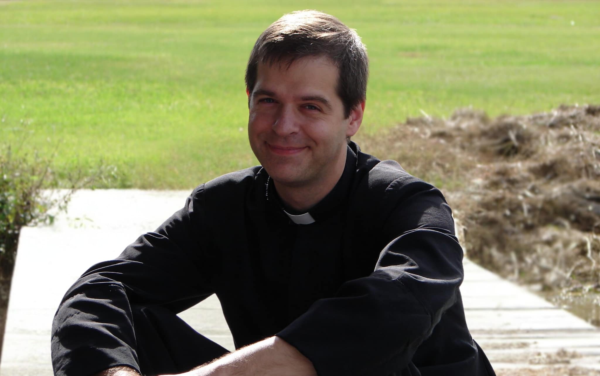 Fr. Henry Kowalczyk SHM sitting relaxed a dock.